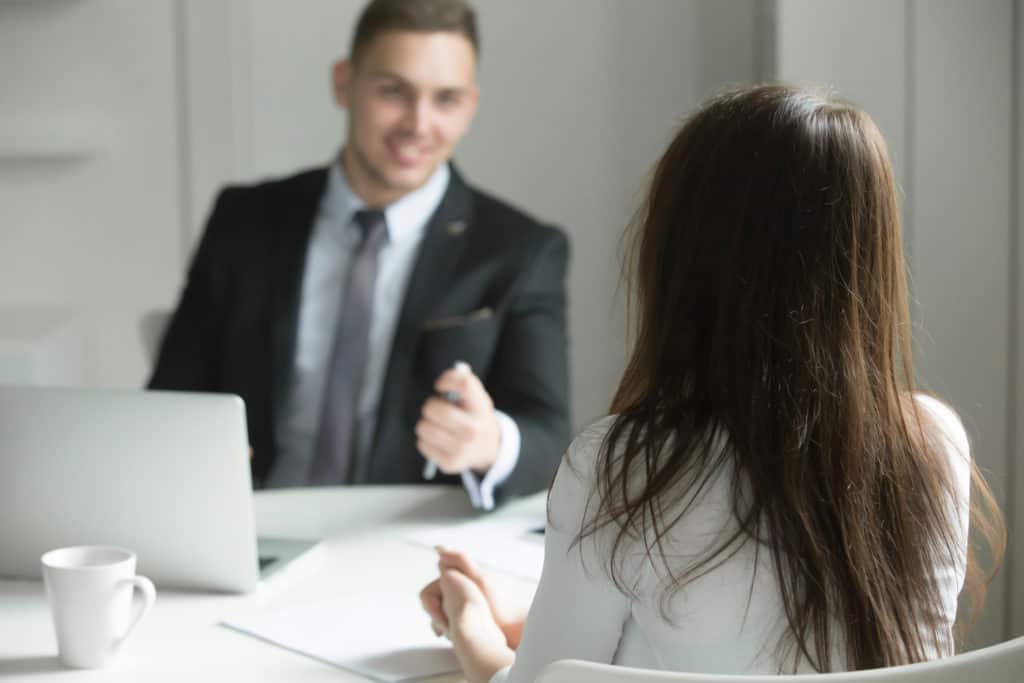 Businessman and Businesswoman Sitting in Room